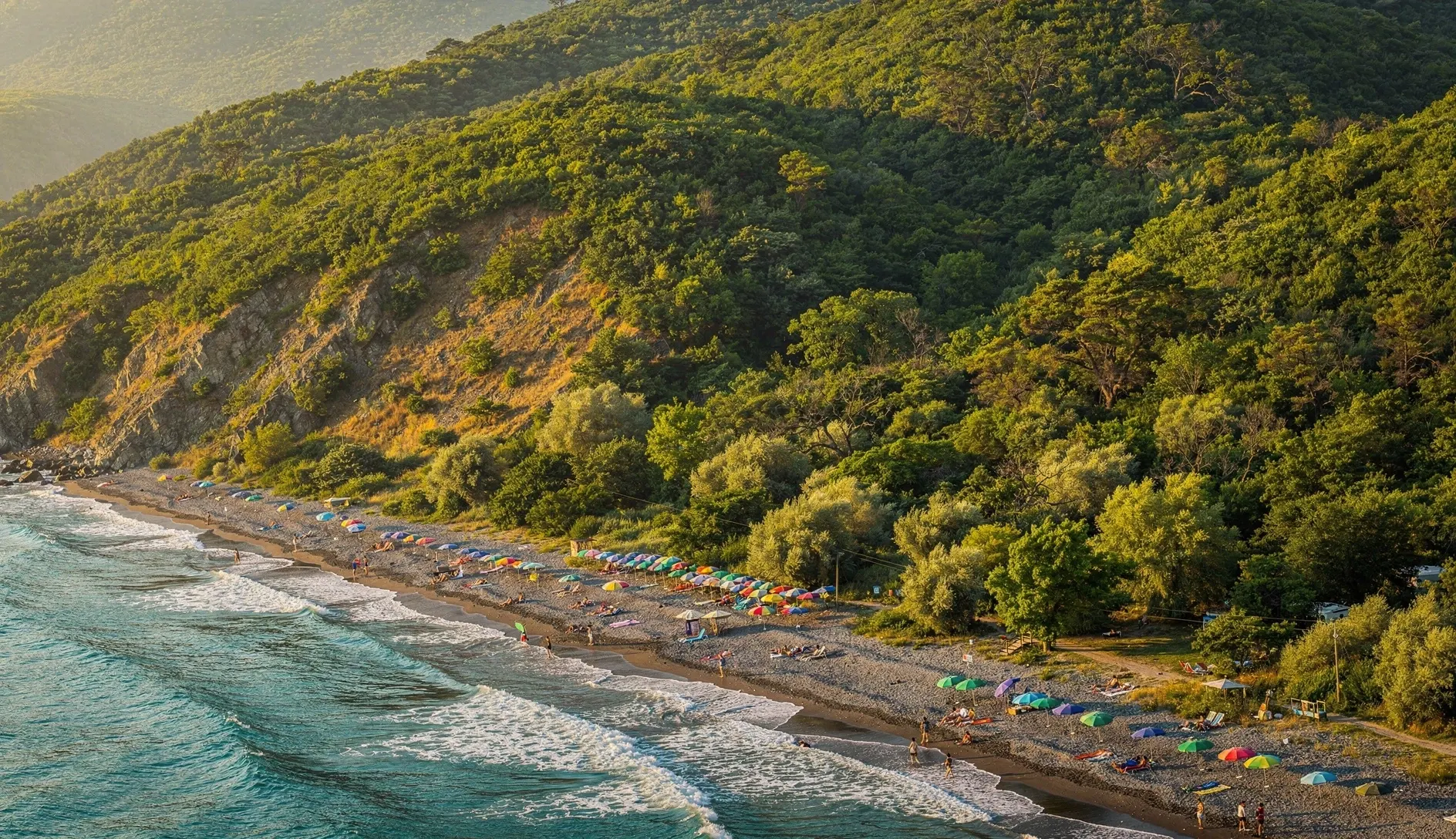 Aerial view of Georgia's Black Sea coastline with turquoise water and green hills