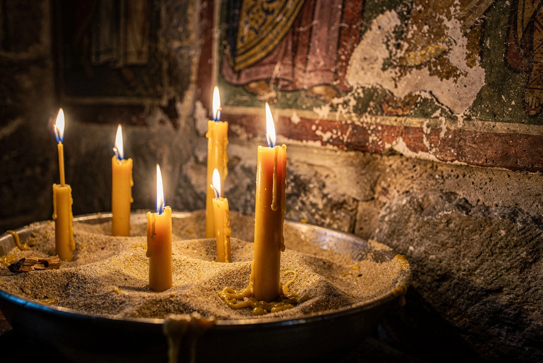 Beeswax candles glowing inside a Georgian Orthodox church