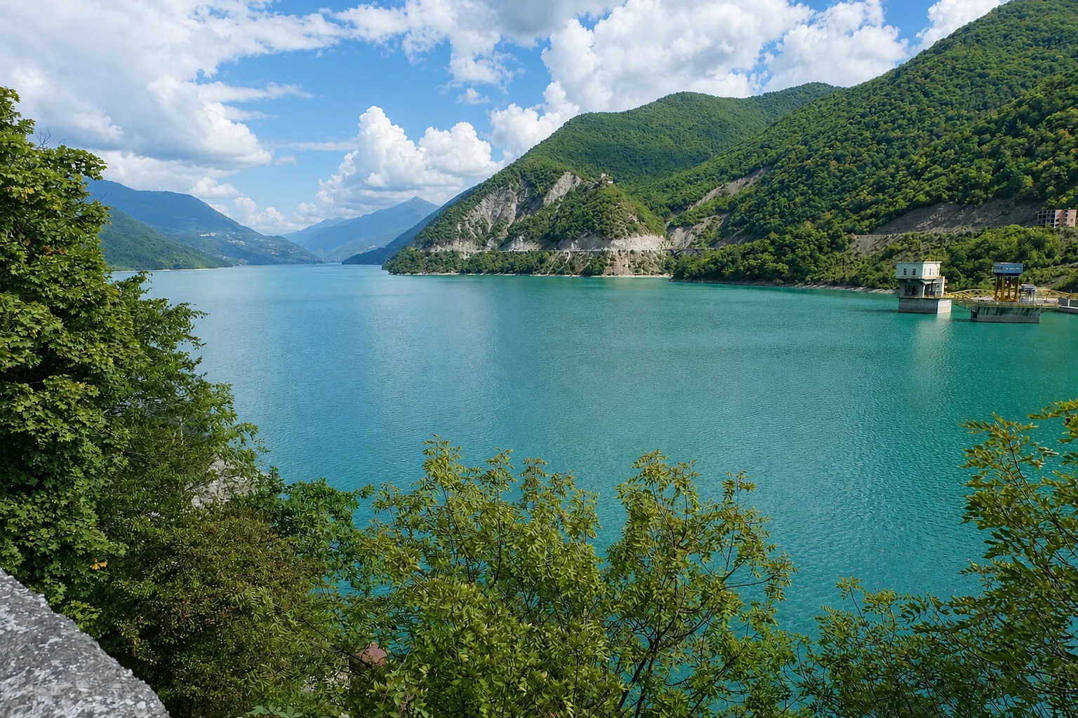 Turquoise Jinvali reservoir below Ananuri with forested mountains on both shores