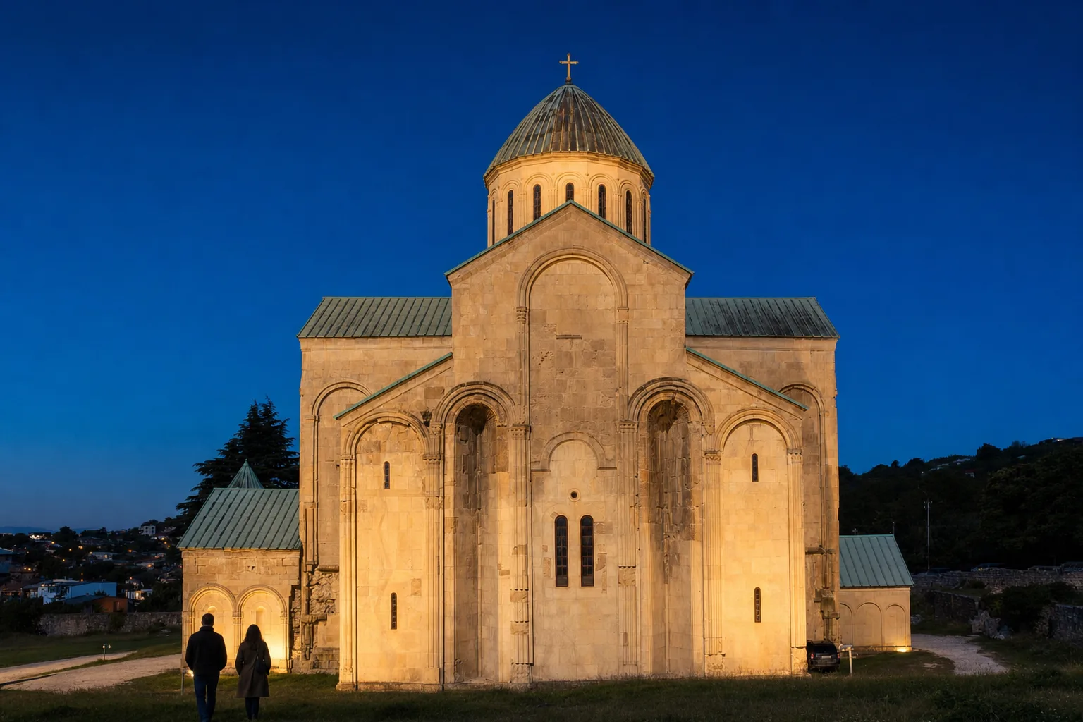 Bagrati Cathedral on its hill above Kutaisi, floodlit at dusk under a deep blue October sky