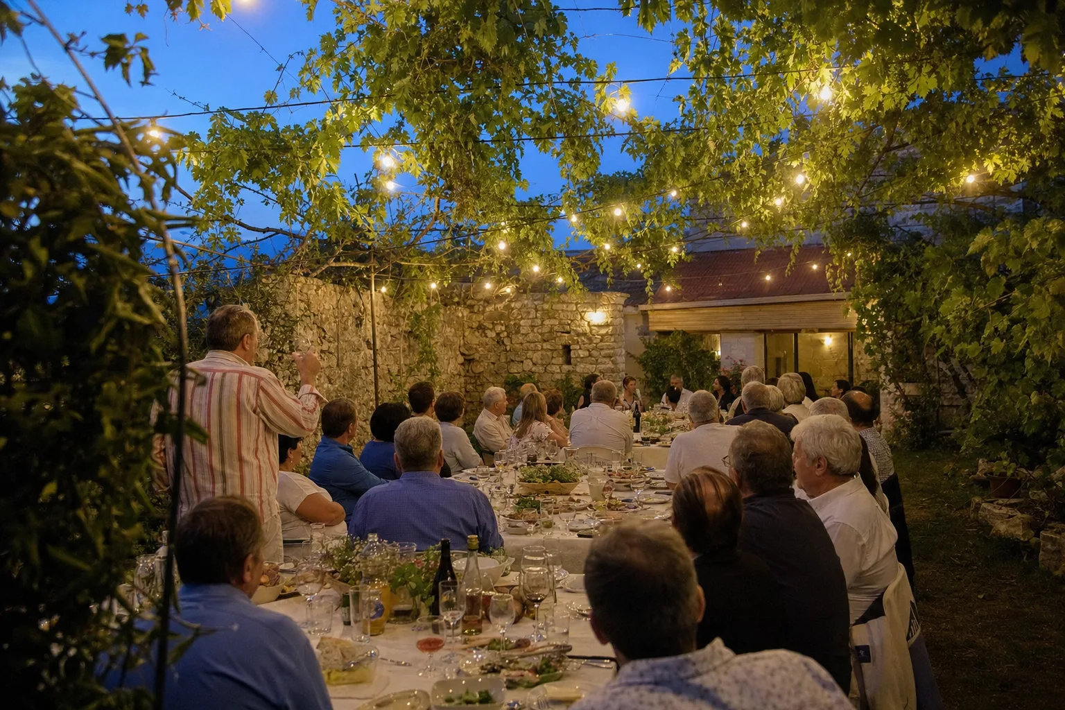 A lavish Georgian supra feast table loaded with traditional dishes, wine, and clay jugs