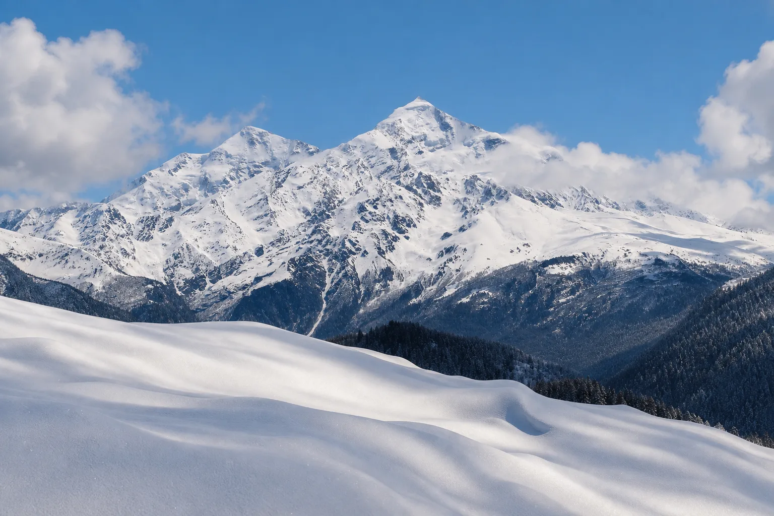 Snow-covered summit of Mount Tetnuldi in Svaneti seen from a winter slope below it