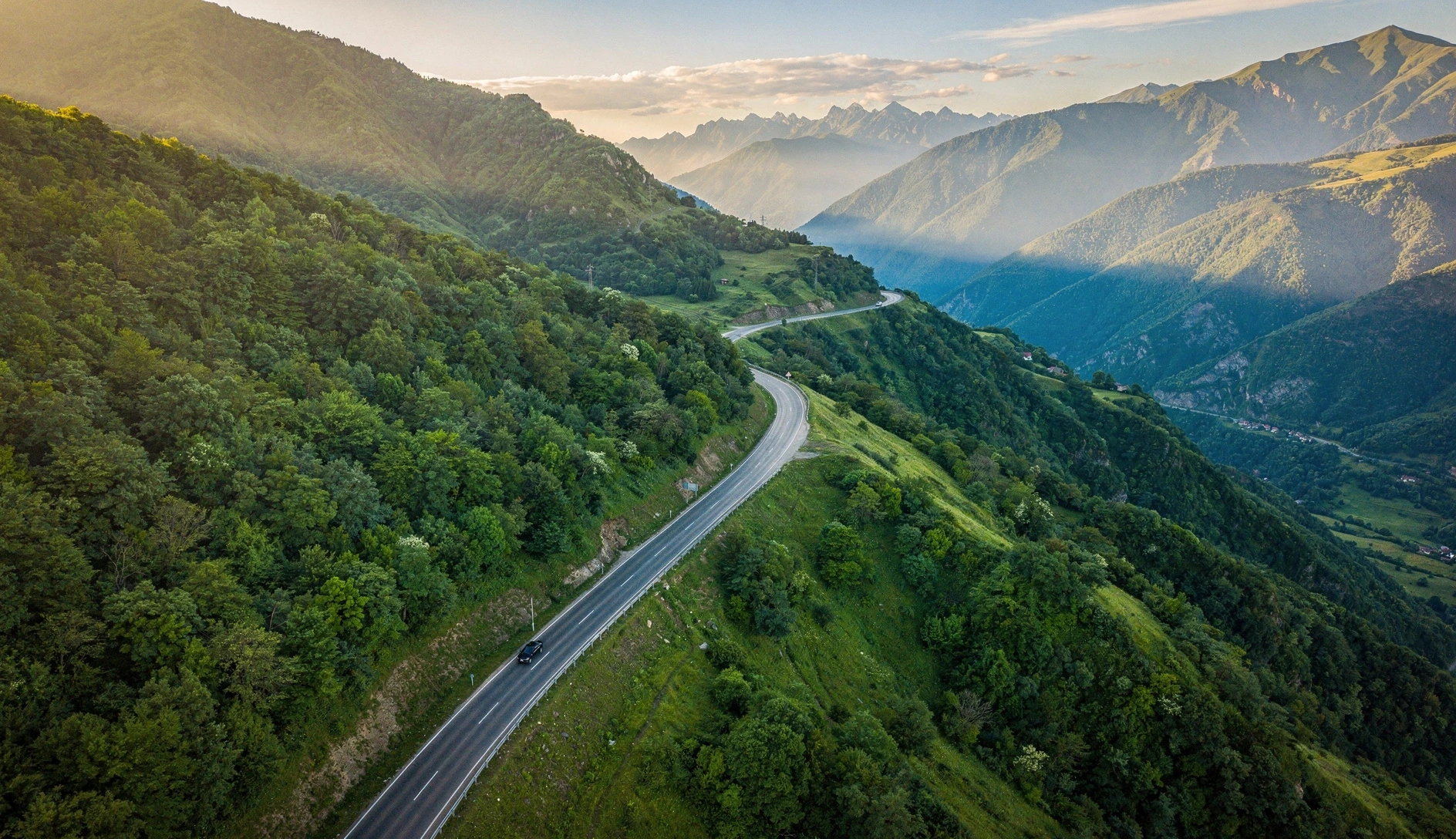Winding mountain highway through the lush green Caucasus mountains in Georgia