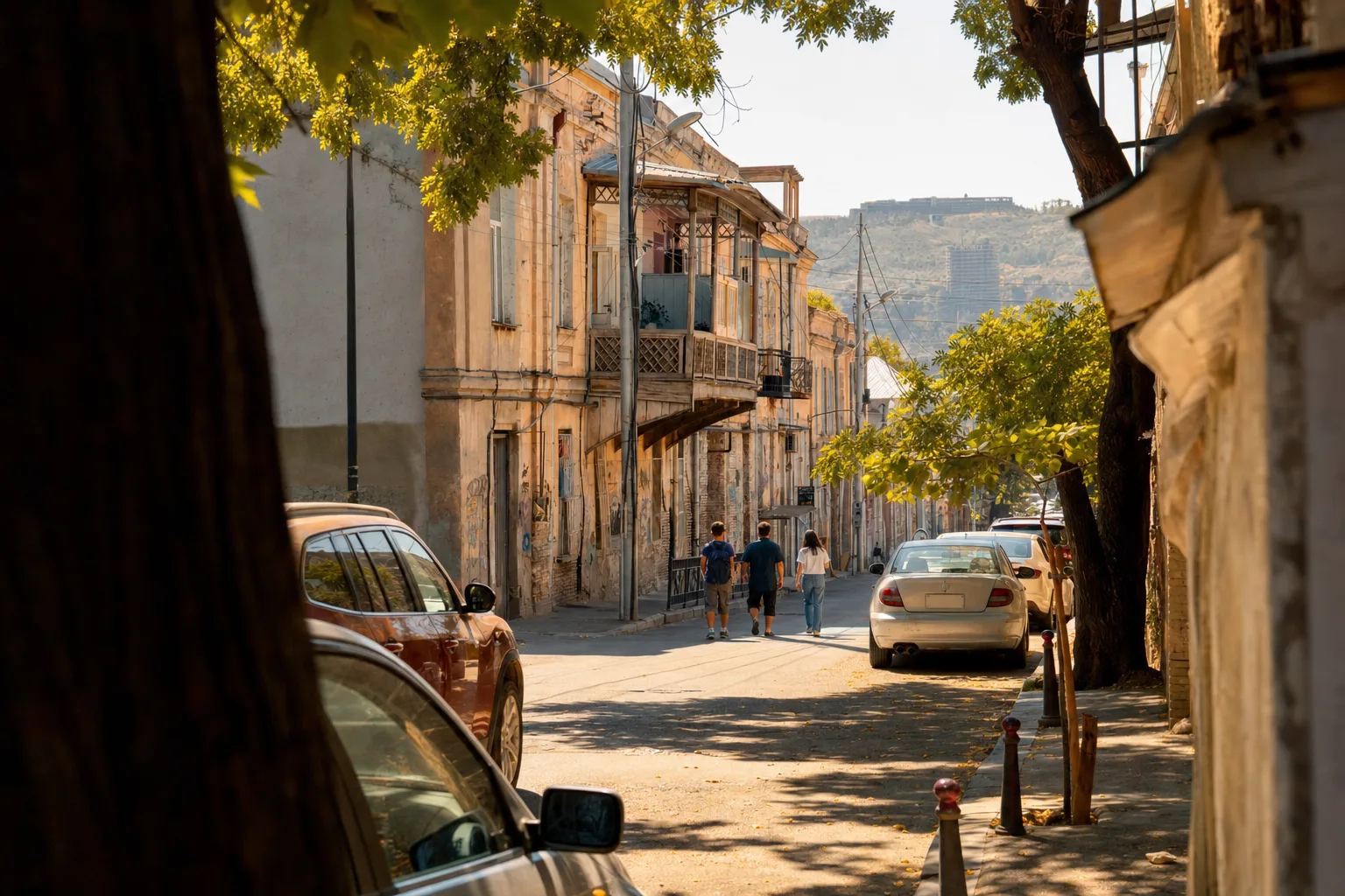 An old Tbilisi street with carved wooden balconies in the early evening