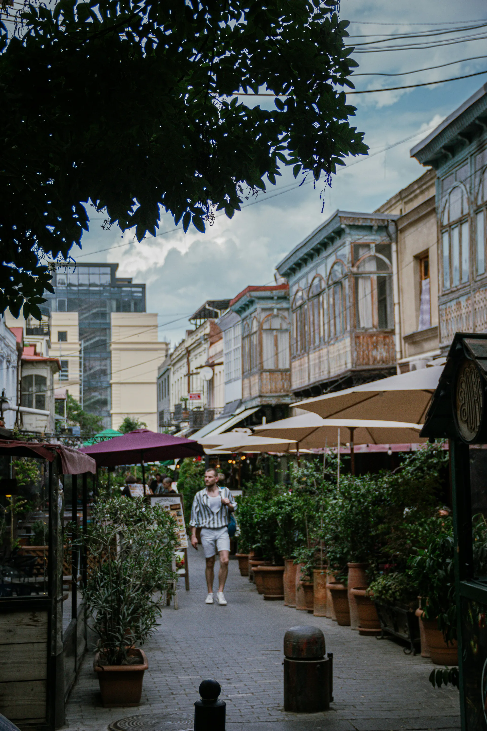 Charming pedestrian street in Tbilisi Old Town with outdoor cafes and traditional buildings