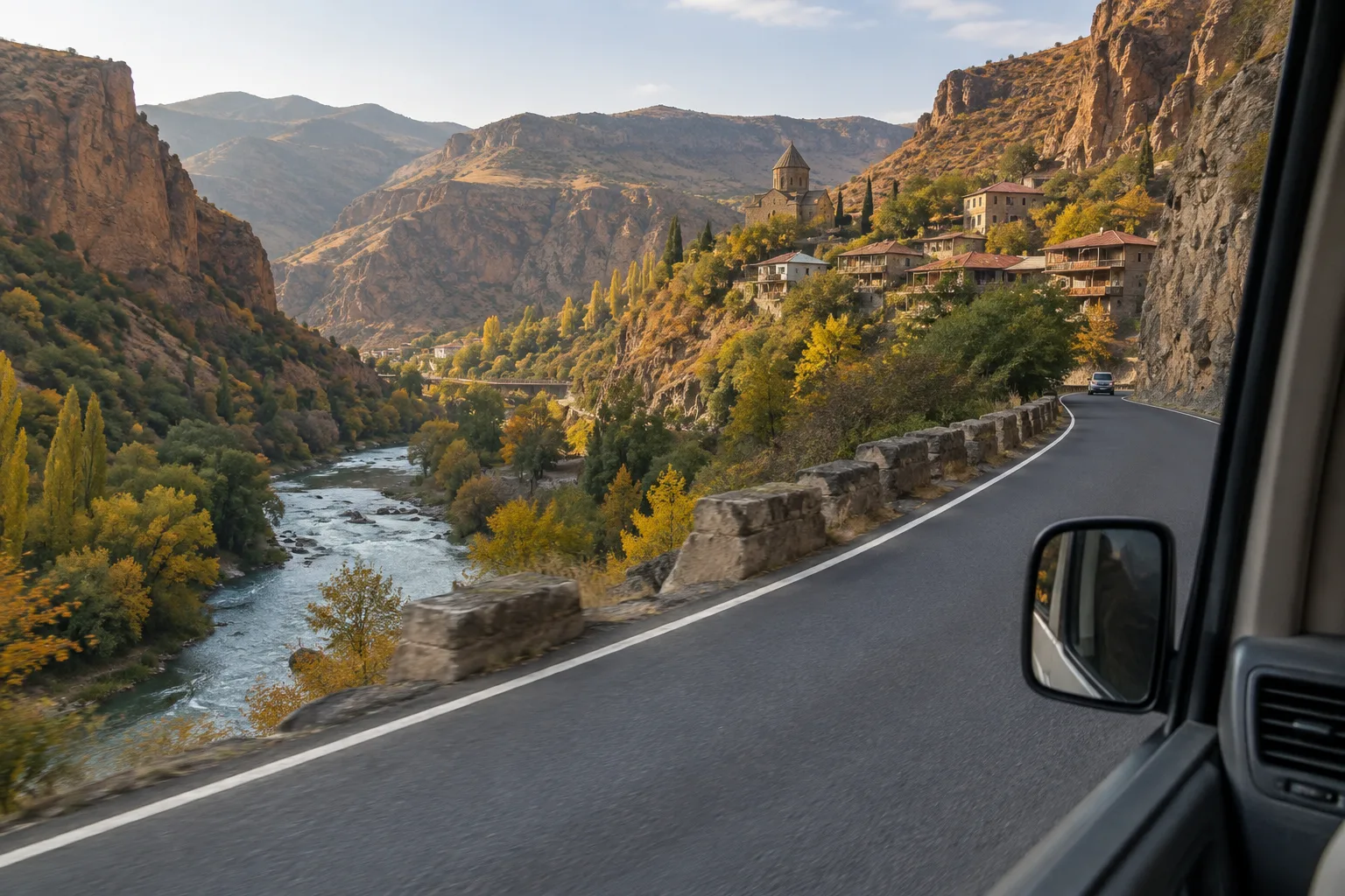 Two-lane road winding through the deep wooded Debed river gorge in northern Armenia, seen from a minibus, with a village and church on the slope above