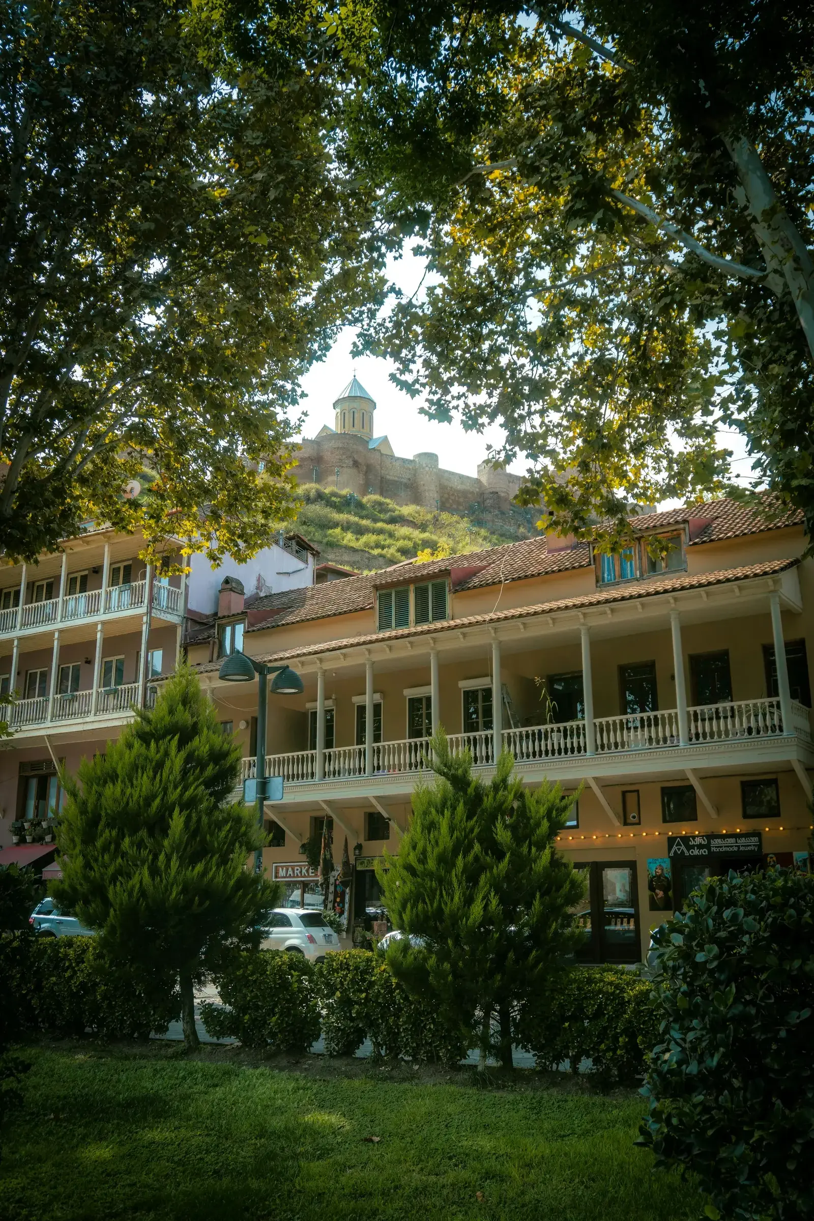Cozy cobblestone street in Tbilisi's Old Town with traditional wooden balconies
