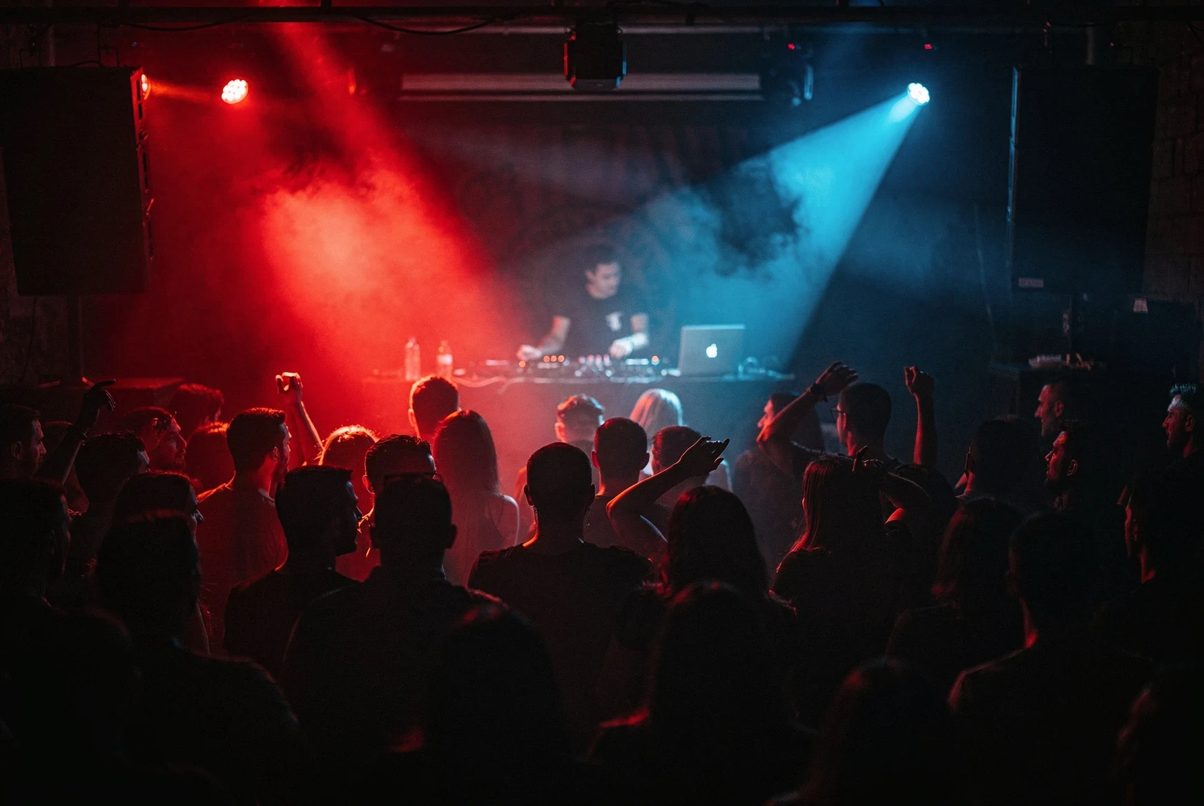 Underground techno club crowd in Tbilisi with red and blue lights