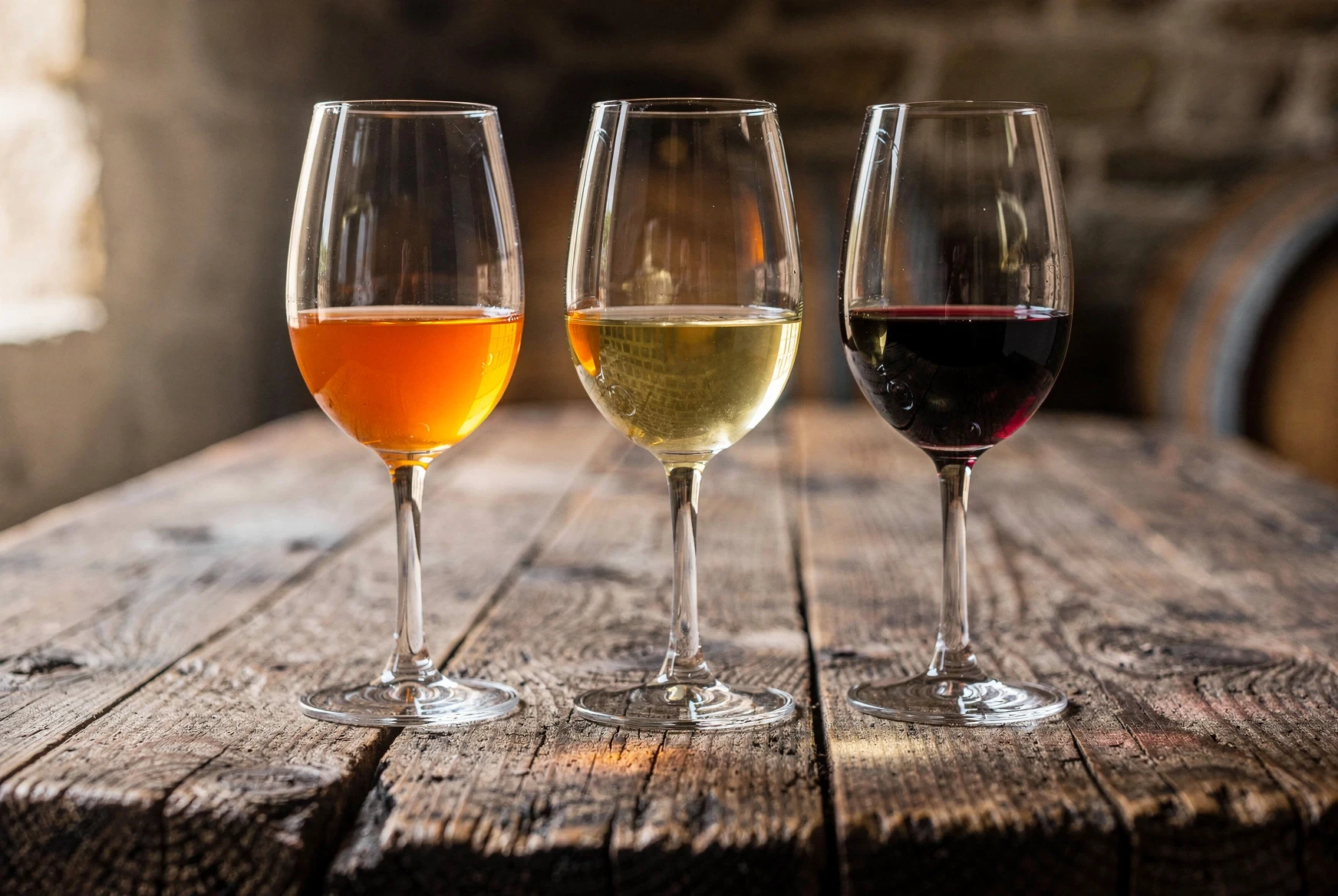 Three glasses of Georgian wine on a rustic tasting table